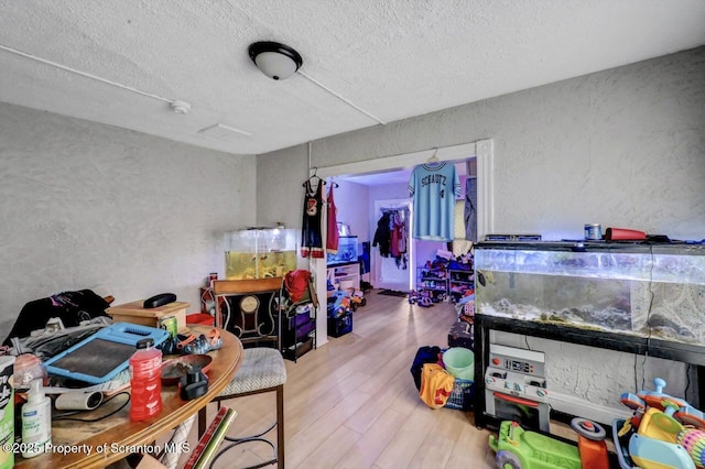 612 Farber Ct, Scranton, PA 18510 - recreation room with a textured wall, a textured ceiling, and wood finished floors