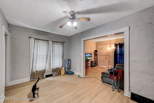 612 Farber Ct, Scranton, PA 18510 - workout room with a ceiling fan, a textured ceiling, wood finished floors, and a textured wall