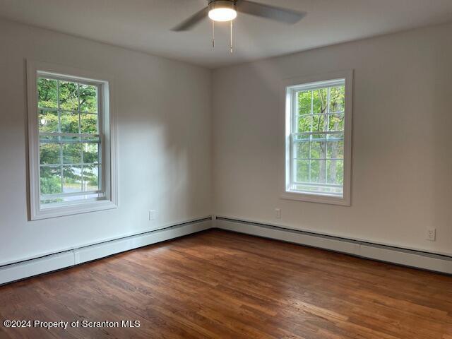 unfurnished room featuring ceiling fan and dark hardwood / wood-style floors