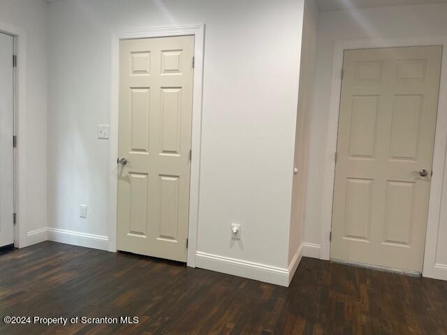 hall featuring dark wood-type flooring