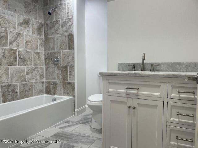 full bathroom featuring toilet, vanity, and tiled shower / bath