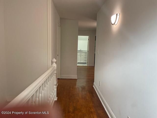 hall with dark hardwood / wood-style flooring