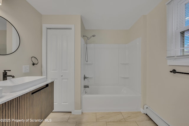 bathroom featuring a baseboard radiator, vanity,  shower combination, and tile patterned flooring