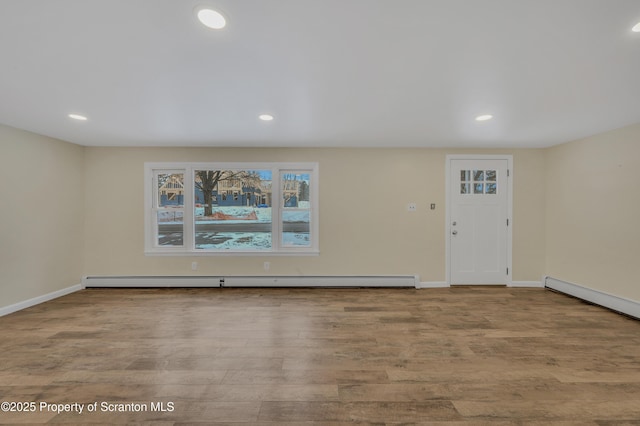 foyer featuring a baseboard radiator and light hardwood / wood-style flooring