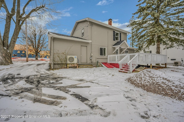 snow covered property featuring a deck and ac unit