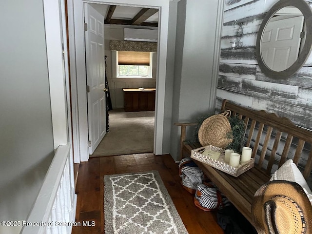 hall featuring beam ceiling and dark wood finished floors