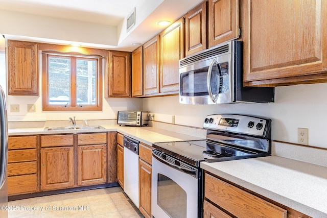 kitchen with sink and appliances with stainless steel finishes