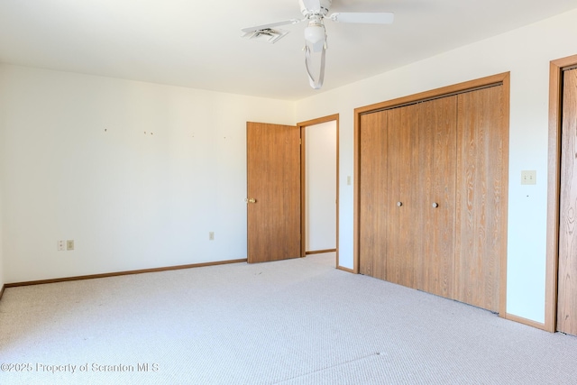 unfurnished bedroom featuring light colored carpet and ceiling fan