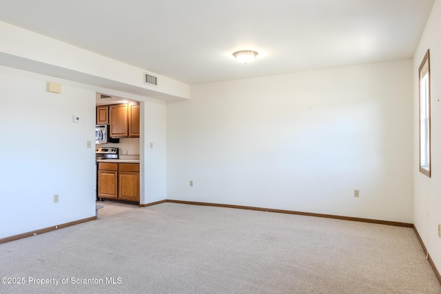 empty room featuring light carpet