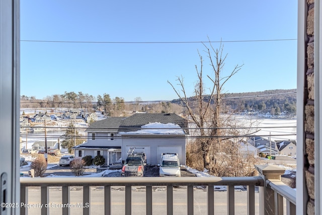 view of snow covered back of property