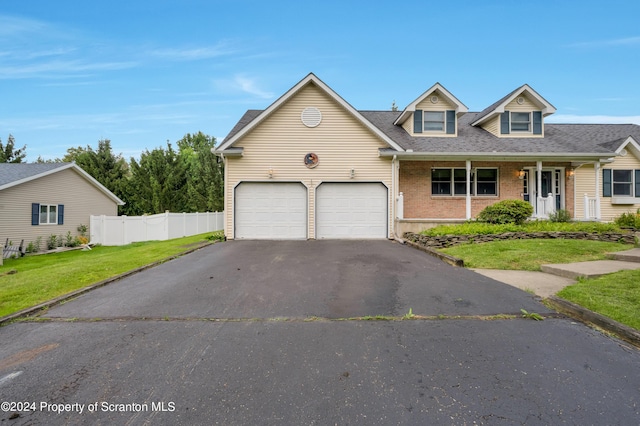 view of front of home featuring a front yard and a garage