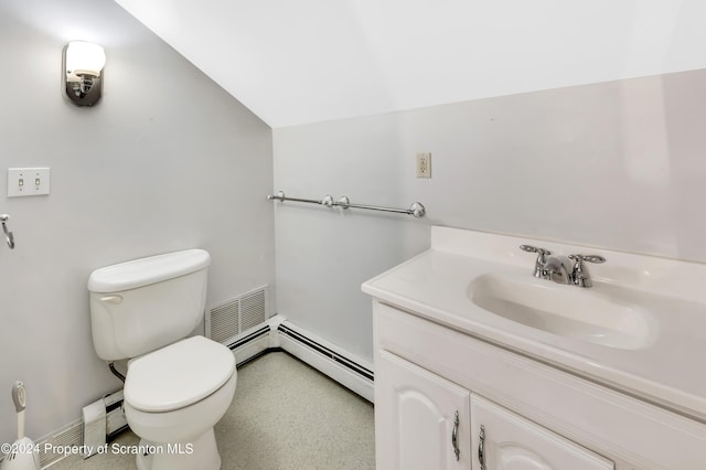 bathroom with baseboard heating, vanity, lofted ceiling, and toilet