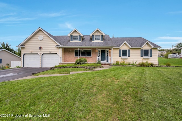 305 Maggies Rd Unit L B, South Abington Twp, PA 18411 - cape cod-style house featuring covered porch, a front yard, and a garage