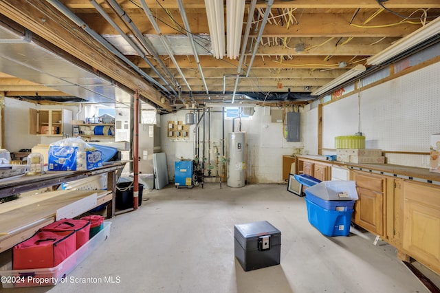 basement featuring electric water heater and electric panel