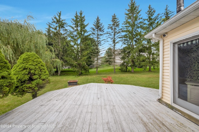 wooden terrace with a yard