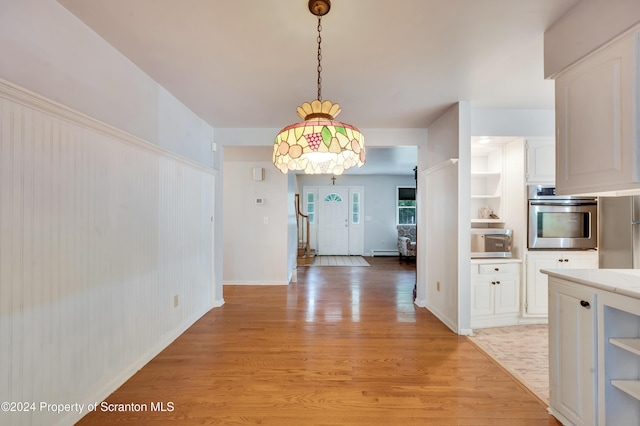 unfurnished dining area featuring light wood-type flooring