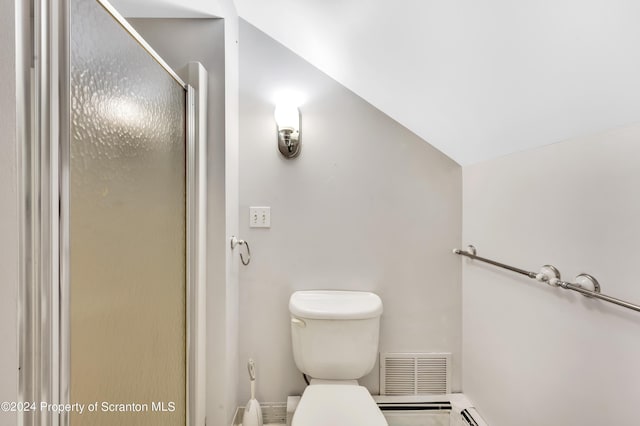 bathroom with a shower with door, vaulted ceiling, and toilet