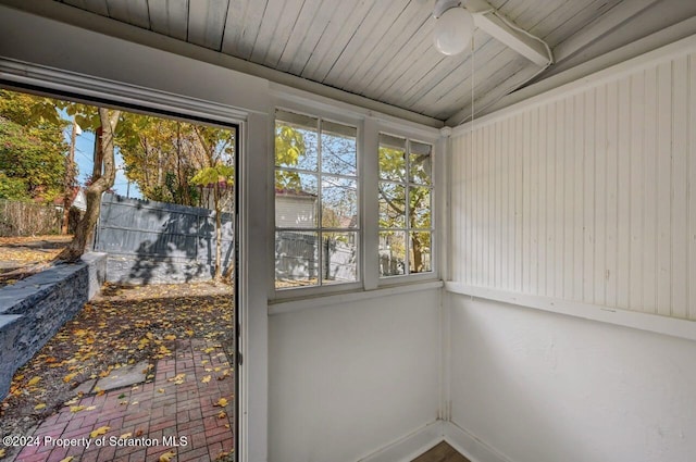 unfurnished sunroom with lofted ceiling and wooden ceiling