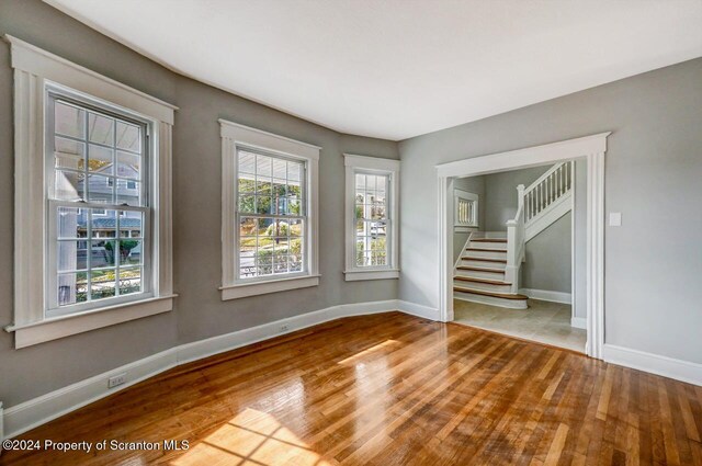 1319 Pine St, Scranton, PA 18510 - spare room featuring wood finished floors and stairs
