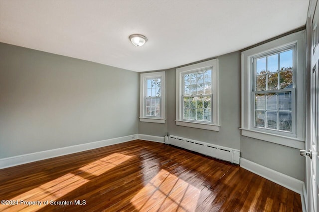 1319 Pine St, Scranton, PA 18510 - empty room with baseboard heating and hardwood / wood-style flooring