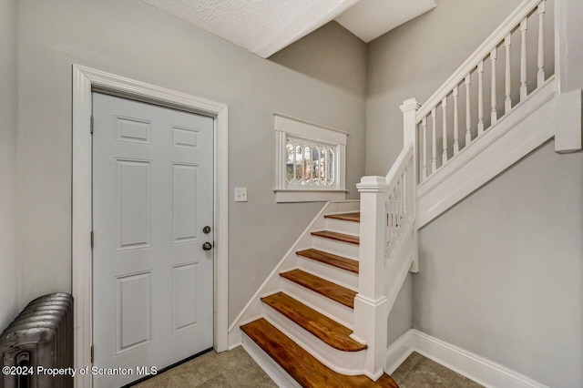 1319 Pine St, Scranton, PA 18510 - foyer entrance featuring radiator heating unit and stairway