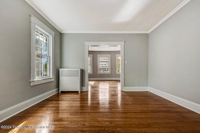 1319 Pine St, Scranton, PA 18510 - unfurnished room featuring healthy amount of natural light, wood finished floors, ornamental molding, and radiator heating unit