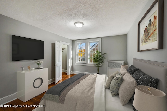 1319 Pine St, Scranton, PA 18510 - bedroom featuring wood finished floors, a textured ceiling, and a closet