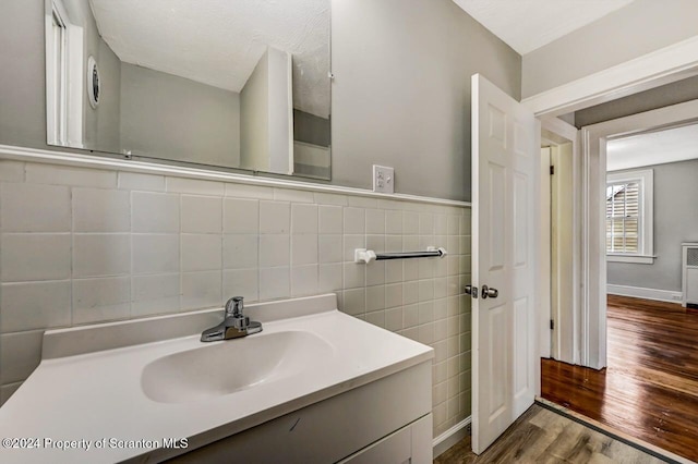 1319 Pine St, Scranton, PA 18510 - bathroom featuring wood finished floors, vanity, and tile walls
