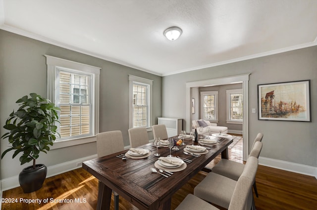 dining area featuring ornamental molding and dark hardwood / wood-style floors