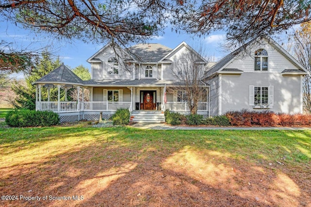 view of front of property with a porch and a front yard