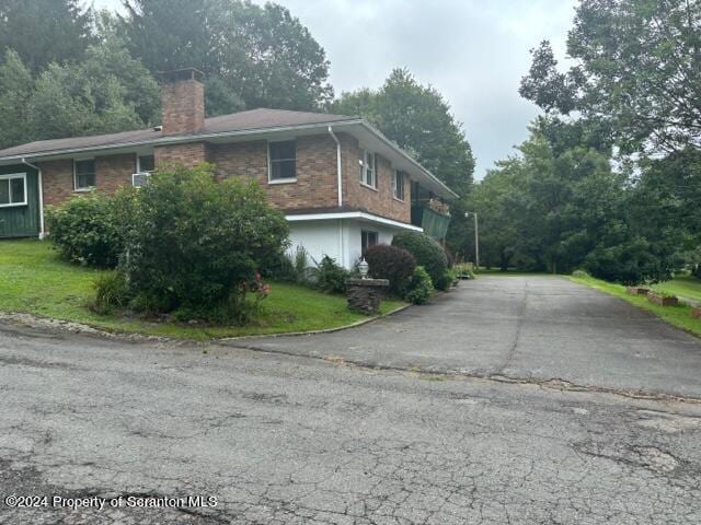 view of property exterior featuring a lawn