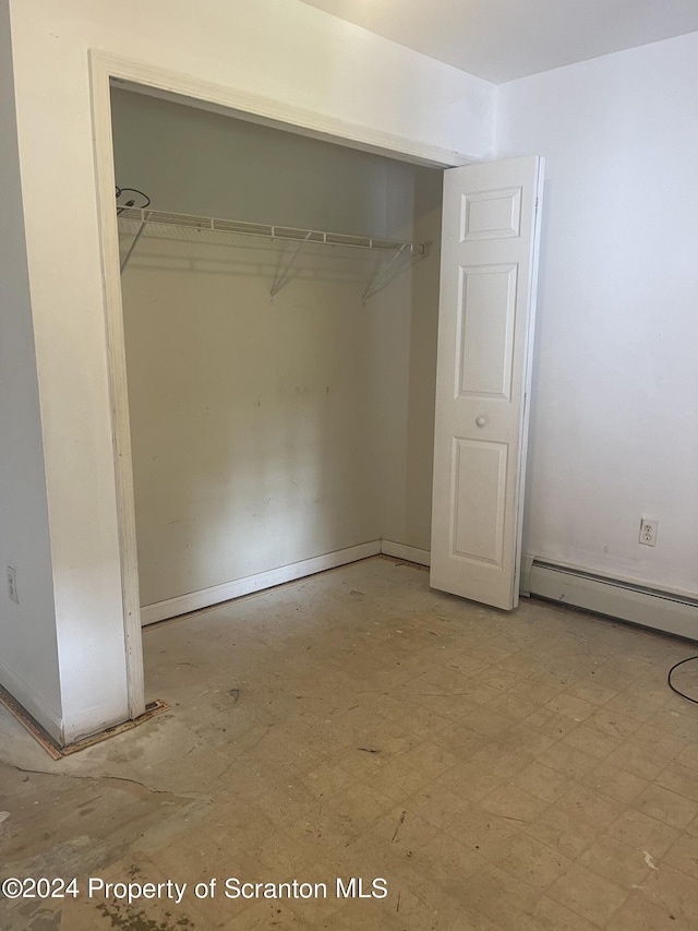 closet with a baseboard heating unit