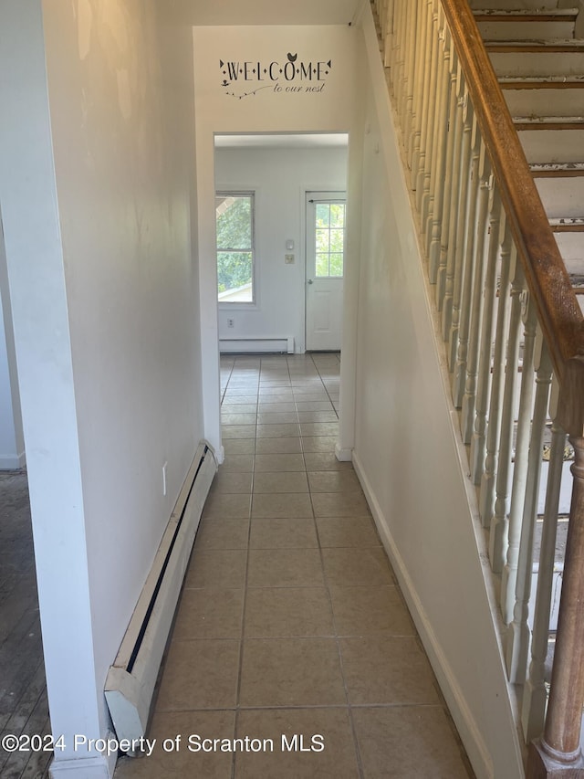 hall featuring baseboard heating and tile patterned floors