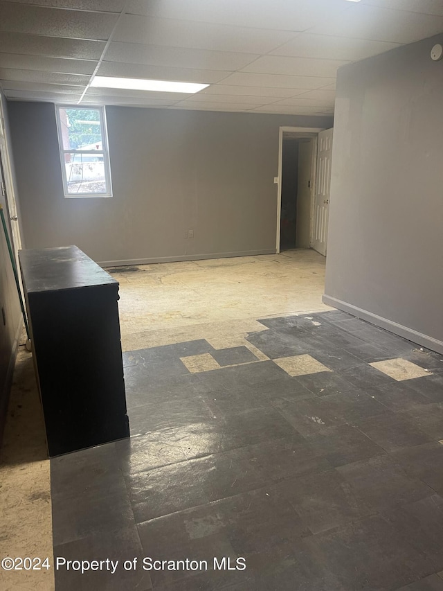 basement featuring a paneled ceiling