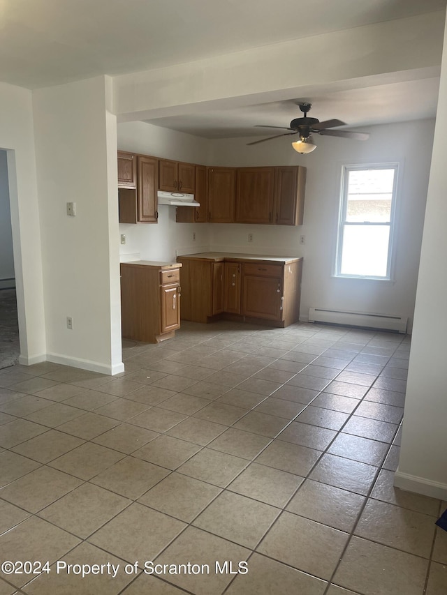 kitchen with ceiling fan, light tile patterned floors, and baseboard heating