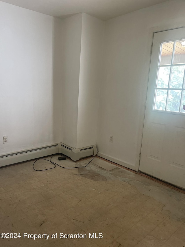 unfurnished room with a baseboard radiator