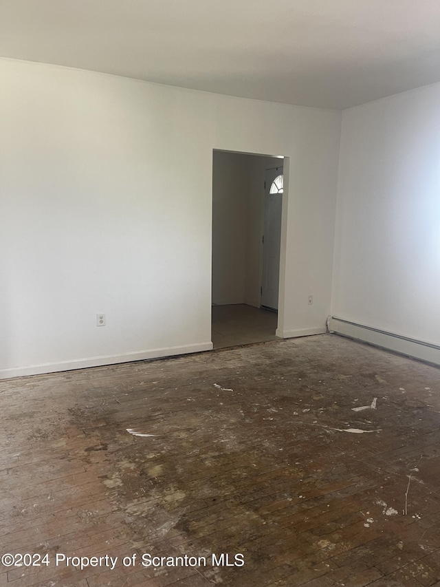 empty room featuring a baseboard radiator