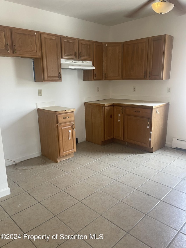 kitchen featuring a baseboard radiator and light tile patterned flooring