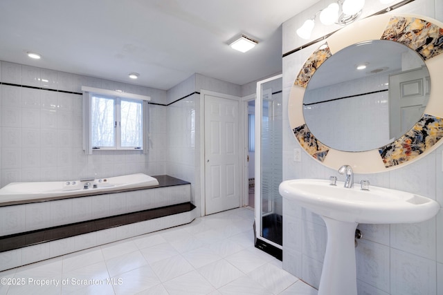 bathroom with sink and tile walls