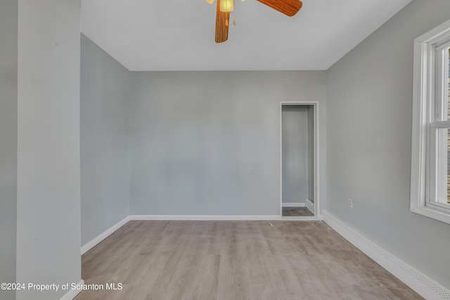 spare room featuring light wood-type flooring and ceiling fan