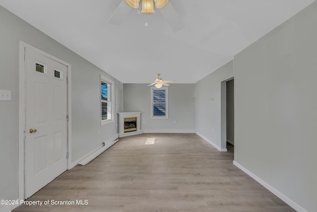 unfurnished living room with light hardwood / wood-style floors and ceiling fan