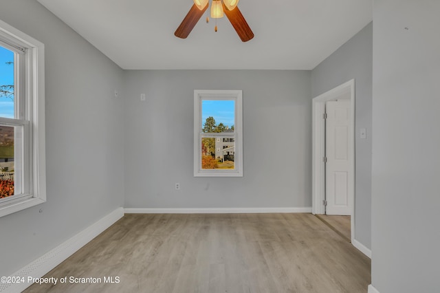 spare room with ceiling fan and light hardwood / wood-style flooring