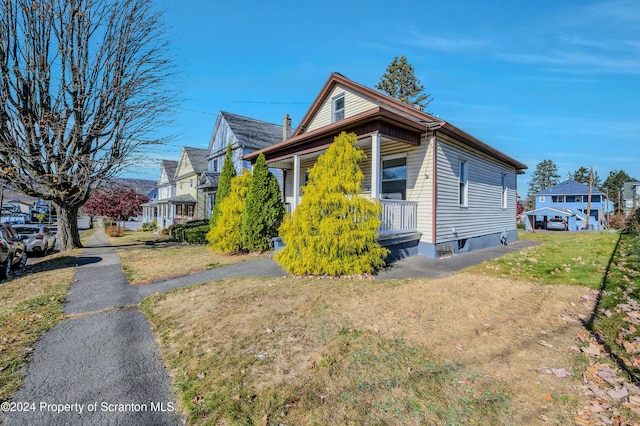 view of side of property with a lawn