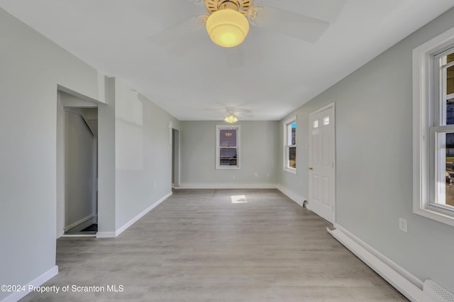 foyer with light wood-type flooring, ceiling fan, and a healthy amount of sunlight