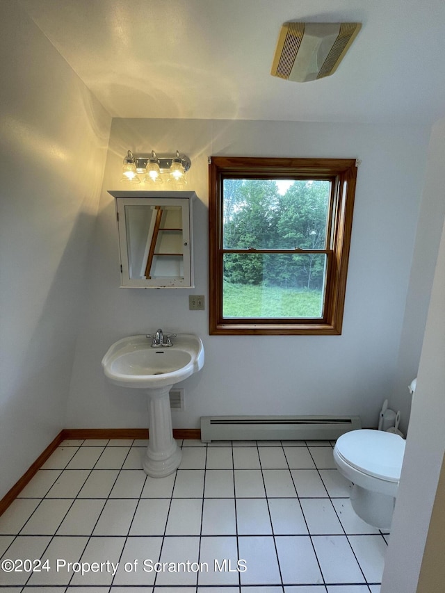 bathroom with tile patterned flooring, sink, toilet, and baseboard heating