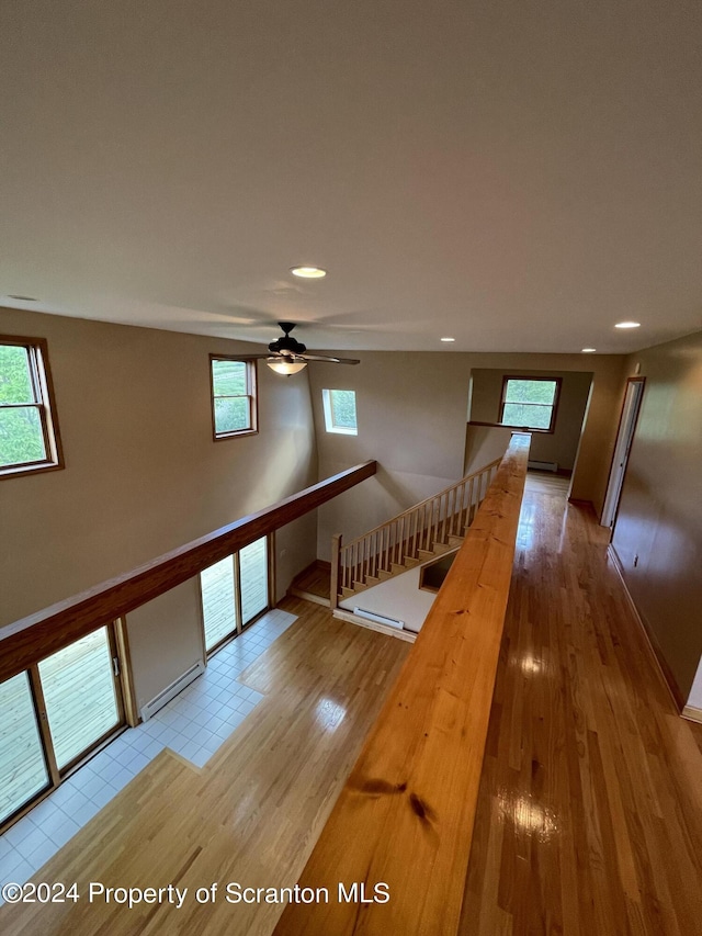 corridor with light hardwood / wood-style flooring