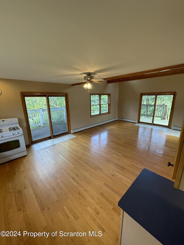 unfurnished living room featuring ceiling fan, baseboard heating, and light hardwood / wood-style flooring