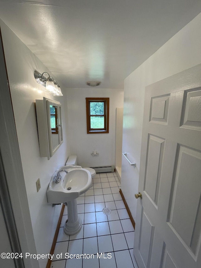 bathroom with baseboard heating and tile patterned flooring