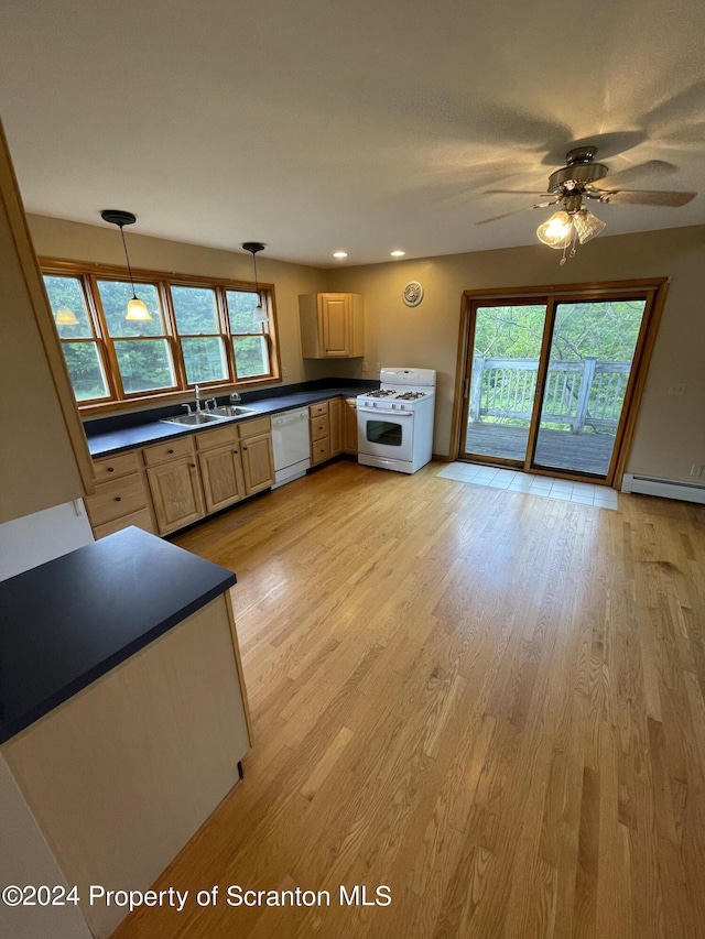 kitchen featuring light wood-type flooring, white appliances, sink, light brown cabinets, and hanging light fixtures