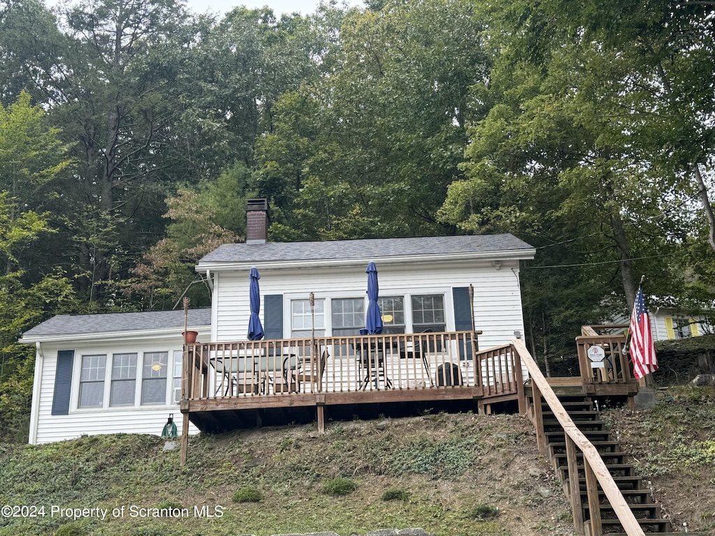 rear view of house featuring a deck